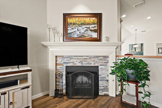 interior space with hardwood / wood-style flooring and a stone fireplace