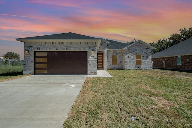 view of front of house with a lawn and a garage