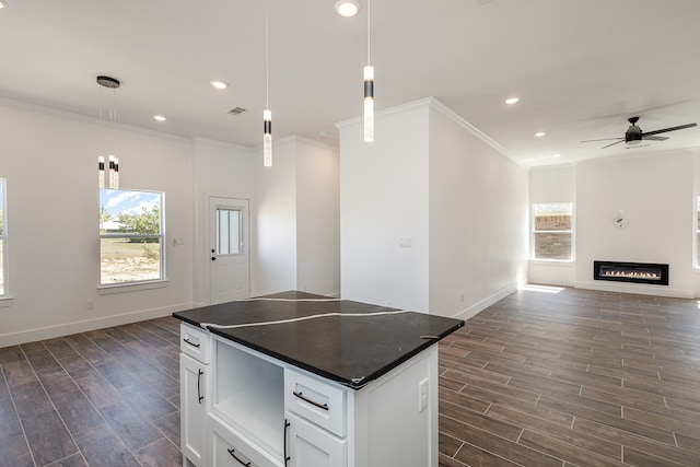 kitchen with pendant lighting, a center island, dark hardwood / wood-style flooring, and white cabinetry