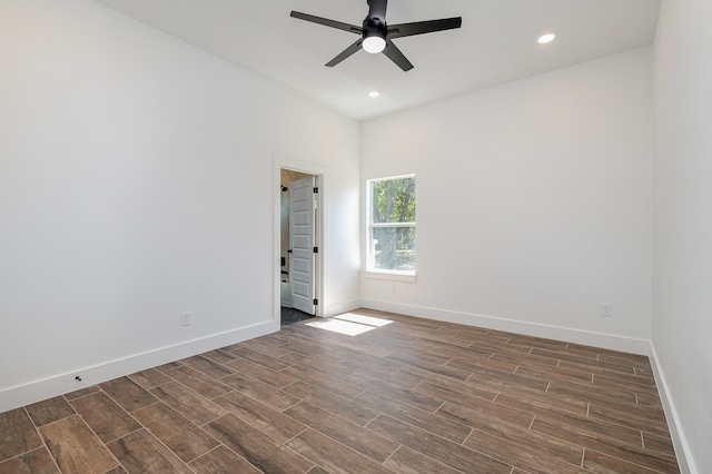 spare room with ceiling fan and dark wood-type flooring