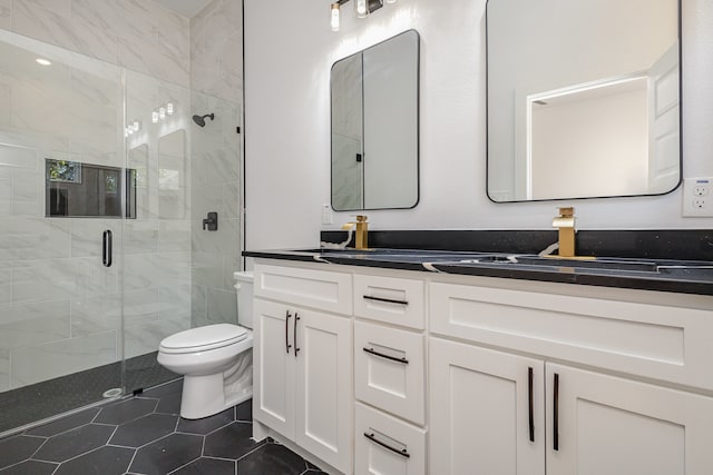 bathroom with tile patterned flooring, vanity, toilet, and an enclosed shower