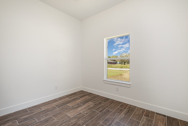 empty room with dark hardwood / wood-style flooring