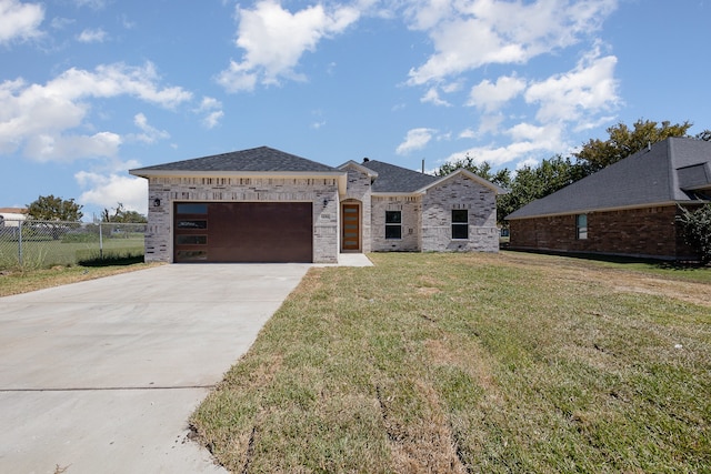 view of front of home with a garage and a front lawn