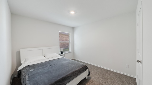 bedroom featuring dark carpet