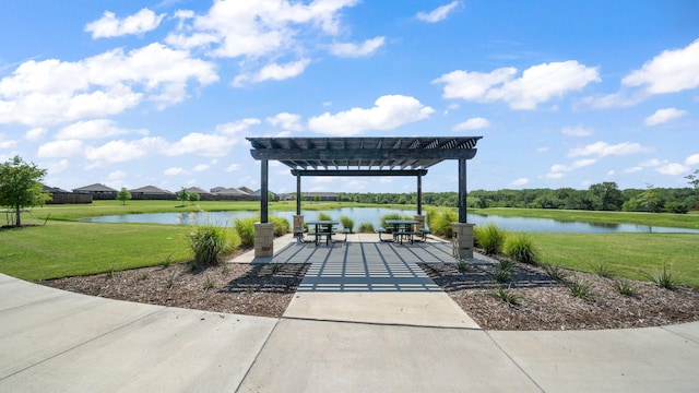 view of patio / terrace with a water view and a pergola