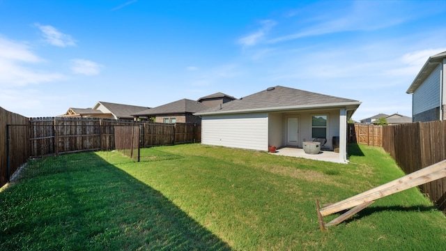 rear view of property with a yard and a patio