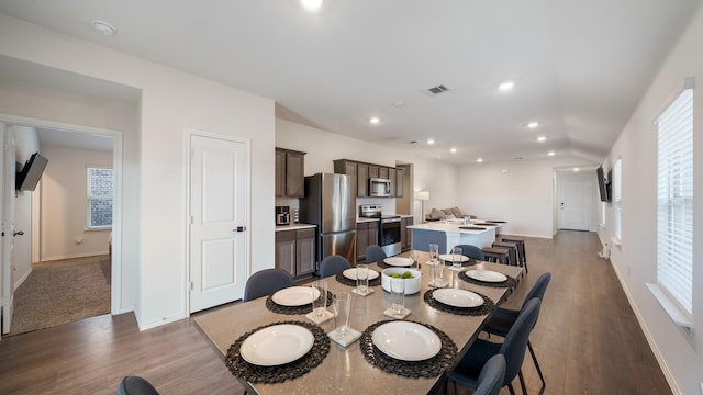 dining space with dark hardwood / wood-style floors