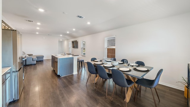 dining room featuring sink and dark hardwood / wood-style floors