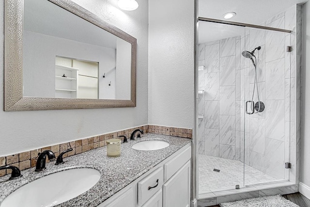 bathroom featuring vanity, a shower with shower door, and wood-type flooring