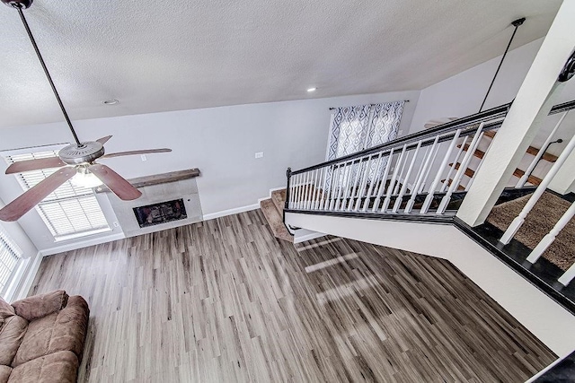 living room featuring wood-type flooring and a textured ceiling