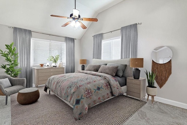 carpeted bedroom with vaulted ceiling, multiple windows, and ceiling fan