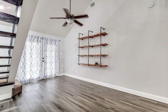 unfurnished living room with plenty of natural light, ceiling fan, wood-type flooring, and high vaulted ceiling