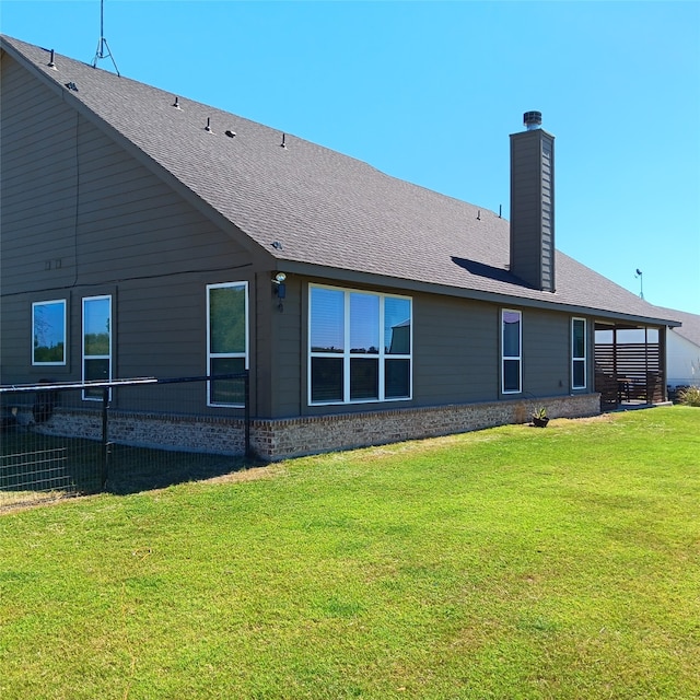 rear view of property featuring a yard