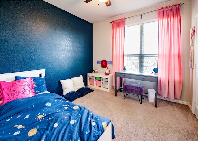 bedroom featuring ceiling fan, carpet flooring, and multiple windows