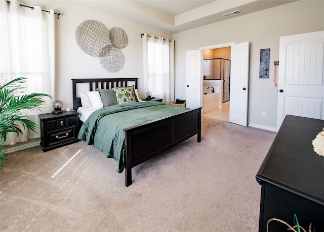 carpeted bedroom featuring connected bathroom