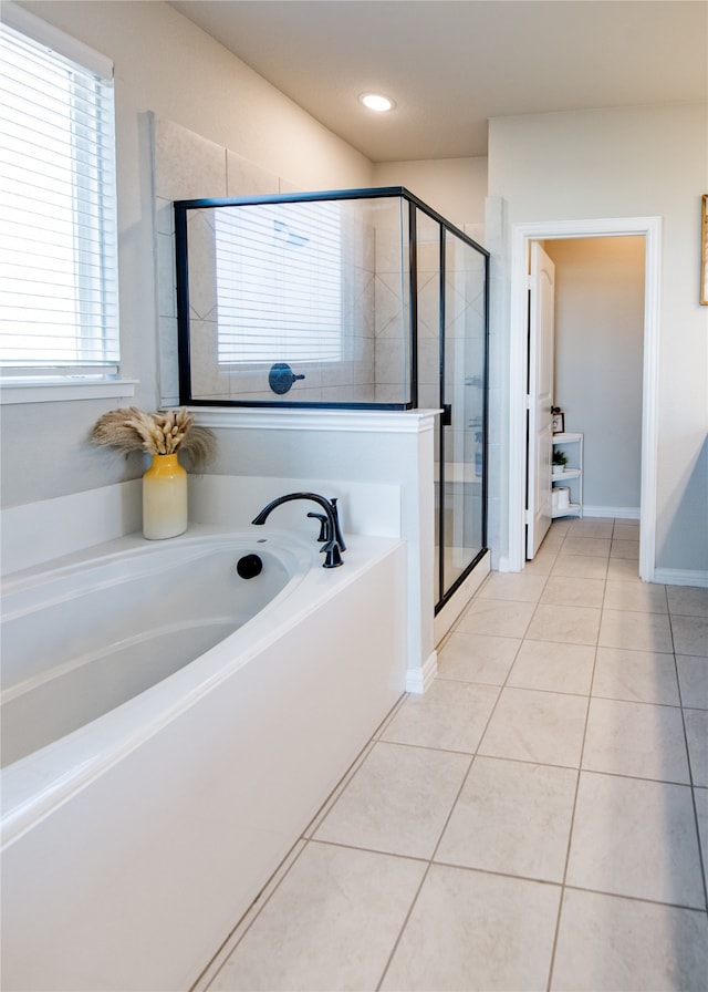 bathroom featuring tile patterned floors and shower with separate bathtub