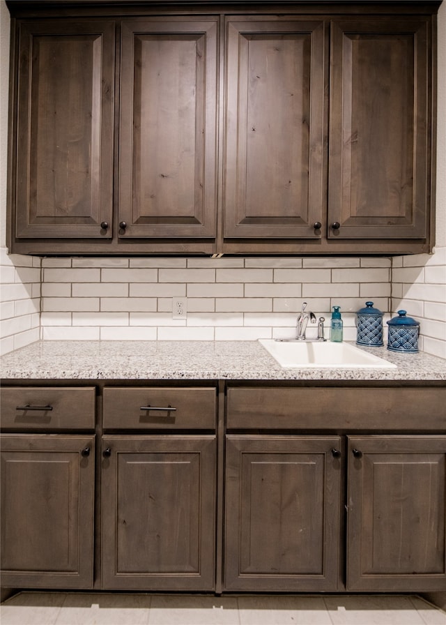 room details featuring decorative backsplash and sink