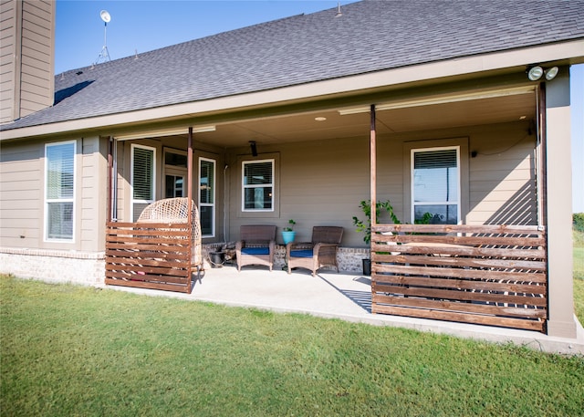 back of house featuring a patio area and a lawn