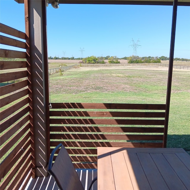 exterior space with a rural view and a yard