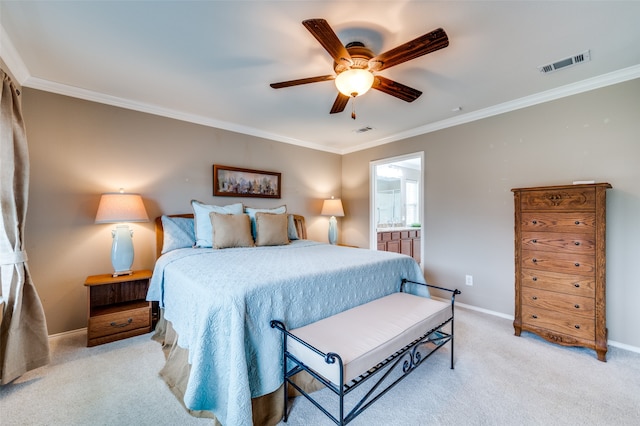 bedroom featuring light carpet, ceiling fan, ensuite bathroom, and crown molding