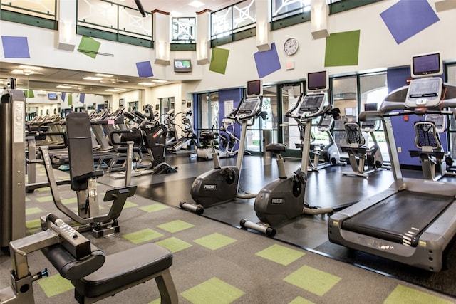 gym with a towering ceiling