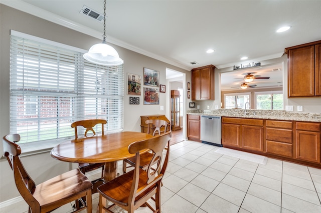 tiled dining room with crown molding, sink, and ceiling fan