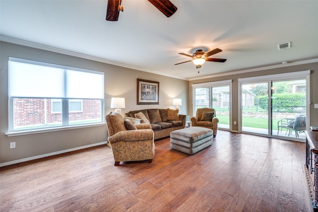 living room featuring ceiling fan, hardwood / wood-style flooring, and crown molding