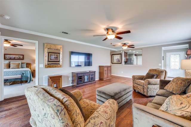 living room featuring crown molding, hardwood / wood-style floors, and ceiling fan