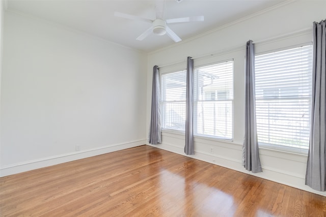 unfurnished room featuring hardwood / wood-style flooring, ceiling fan, and crown molding