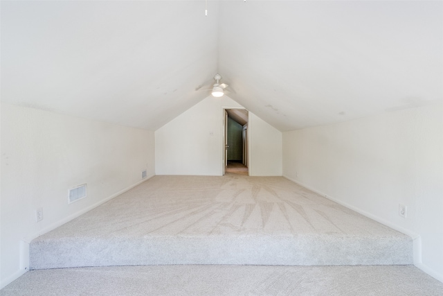 additional living space with light colored carpet and lofted ceiling