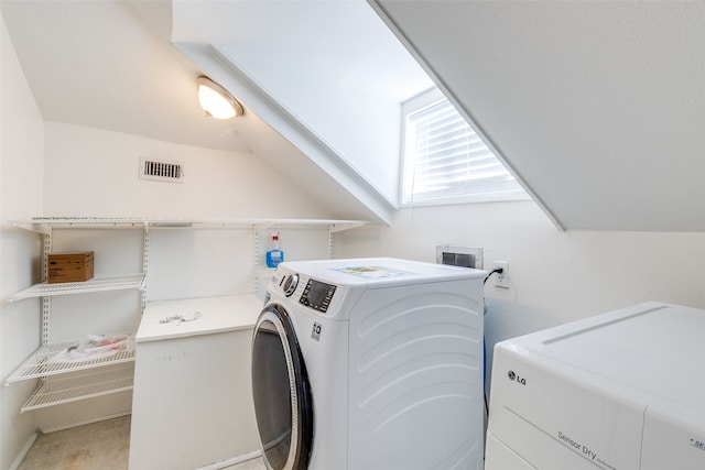 washroom featuring washing machine and dryer