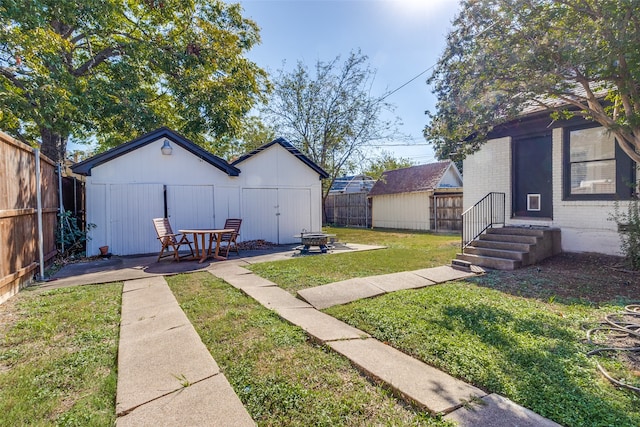 view of yard with a patio area and a storage shed