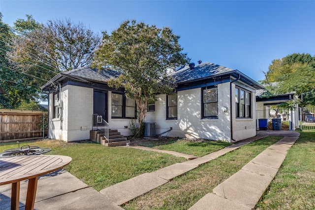 bungalow featuring central AC and a front lawn