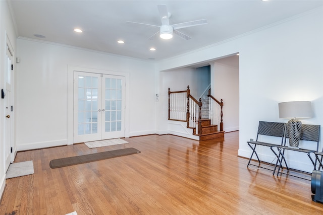 interior space featuring ceiling fan, light hardwood / wood-style floors, ornamental molding, and french doors