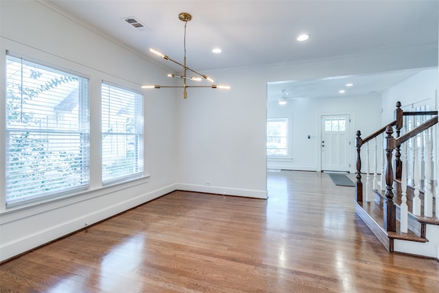 dining area with a chandelier, hardwood / wood-style flooring, and a wealth of natural light