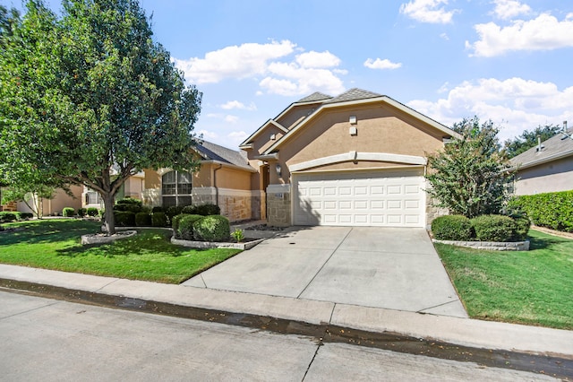 view of front of property with a garage and a front lawn