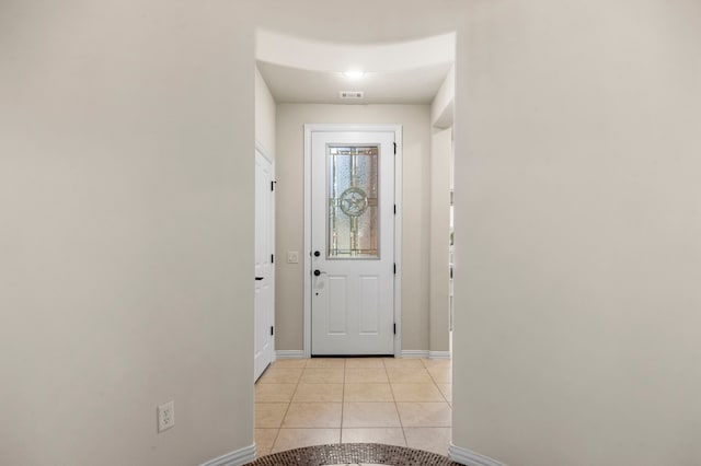 doorway with light tile patterned floors