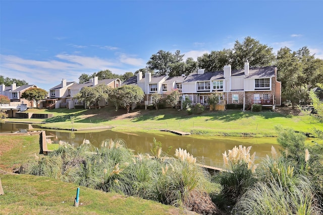 exterior space featuring a yard and a water view