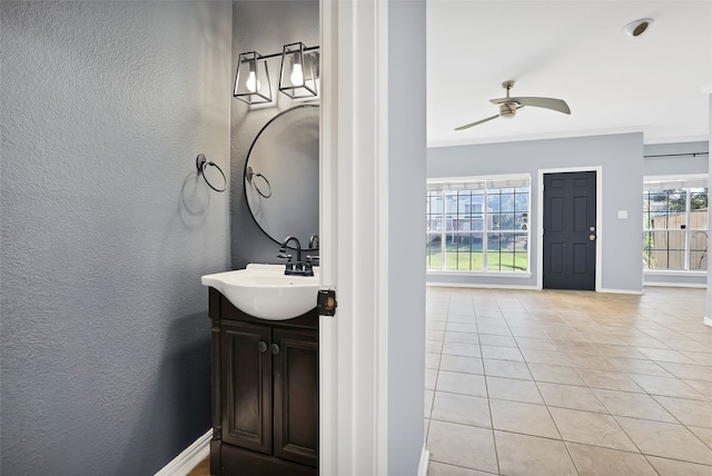 bathroom with tile patterned floors, ceiling fan, ornamental molding, and vanity