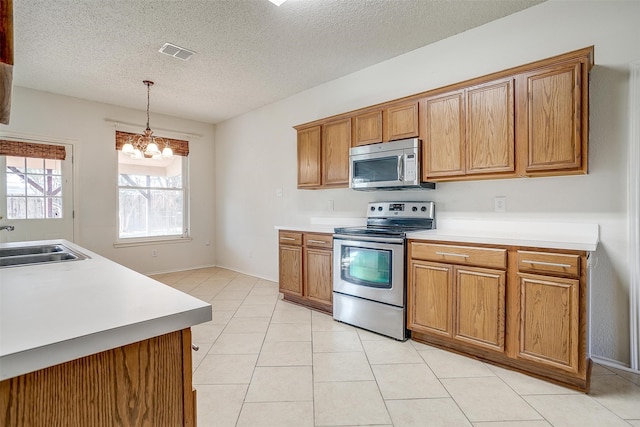 kitchen featuring pendant lighting, light tile patterned flooring, sink, a notable chandelier, and stainless steel appliances