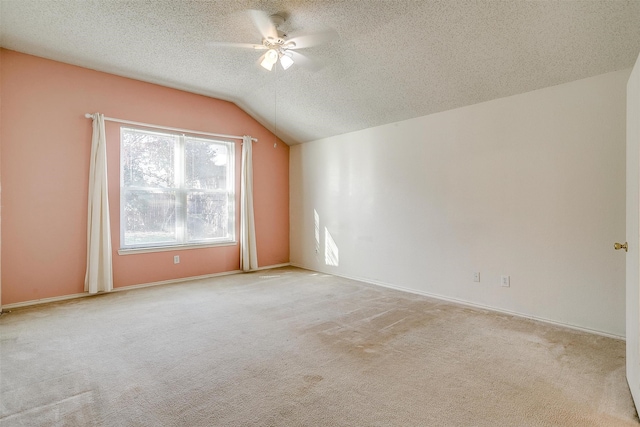 interior space with ceiling fan, light colored carpet, a textured ceiling, and vaulted ceiling