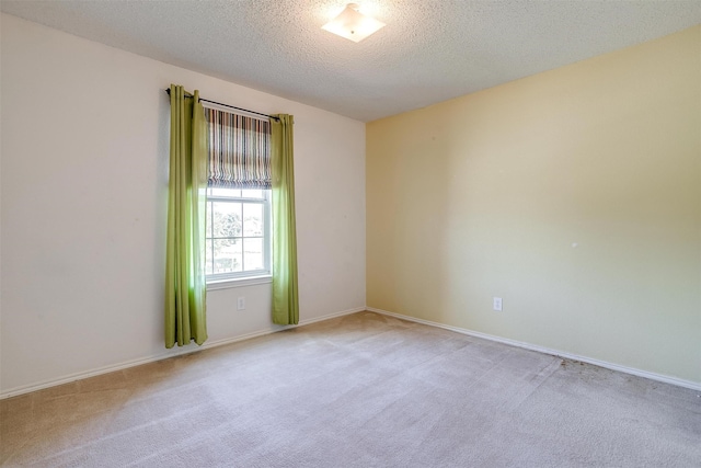 carpeted spare room featuring a textured ceiling