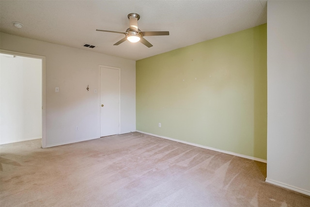 empty room with light carpet and ceiling fan