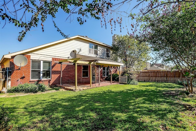 rear view of house featuring a patio area and a yard