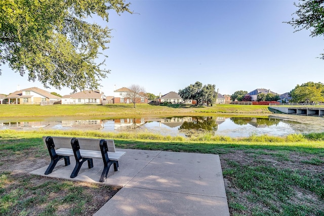 surrounding community with a patio and a water view