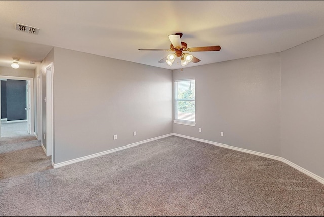 empty room with ceiling fan and carpet flooring