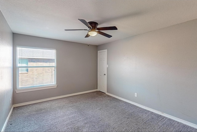 empty room featuring carpet floors, a textured ceiling, and ceiling fan