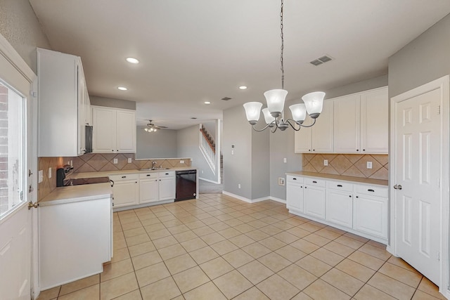 kitchen with pendant lighting, dishwasher, plenty of natural light, and white cabinets