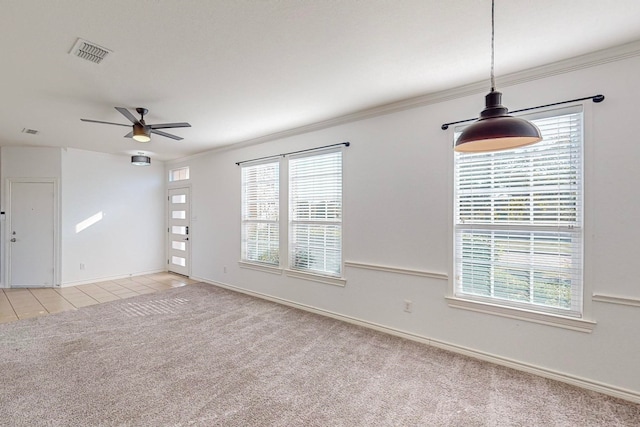 carpeted spare room featuring ceiling fan and crown molding