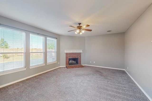 unfurnished living room with carpet flooring, ceiling fan, and a fireplace